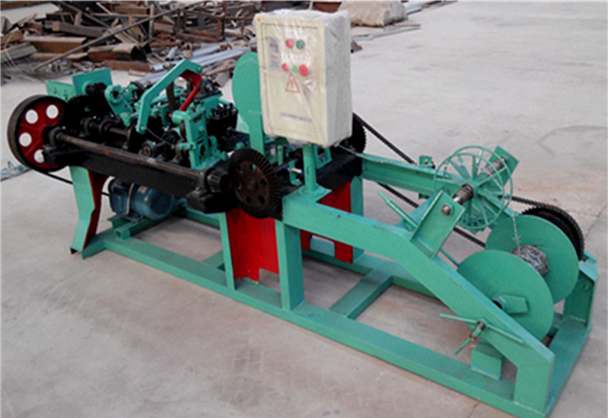 Barbed wire making machine